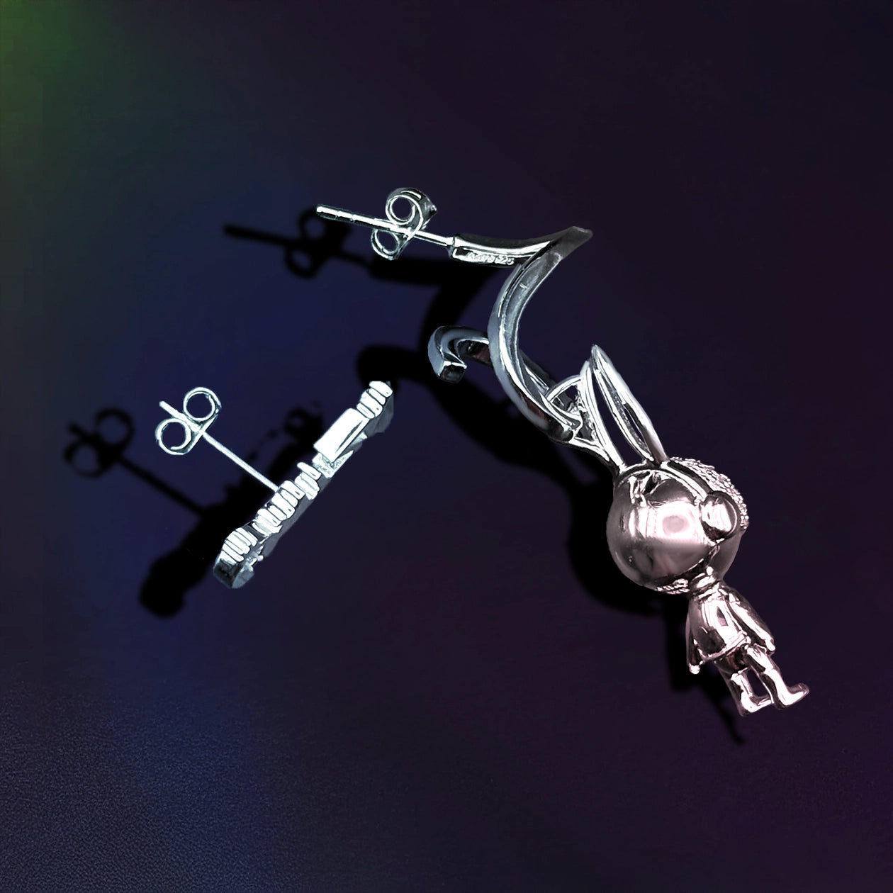 Silver earring on a dark background