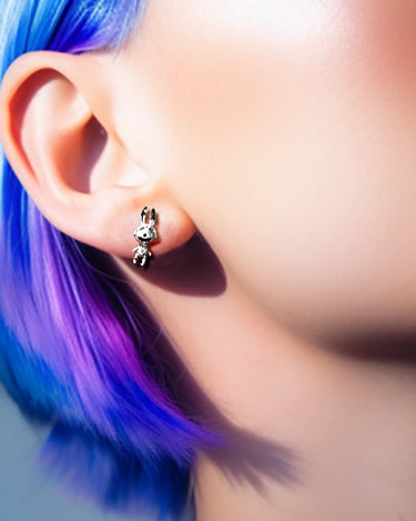 studs earrings on the ear